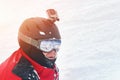 Snowboarder or skier portrait in sport goggles and protection helmet with mounted action camera and ski slope on background. Royalty Free Stock Photo