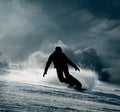 Snowboarder slides down the snowy hill