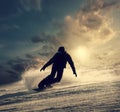 Snowboarder slides down the snowy hill