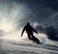 Snowboarder slides down the snowy hill