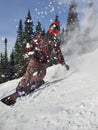 A snowboarder in the snow. A young man is a snowboarder running down a slope. Winter sports and recreation, outdoor Royalty Free Stock Photo