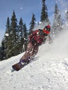 A snowboarder in the snow. A young man is a snowboarder running down a slope. Winter sports and recreation, outdoor Royalty Free Stock Photo