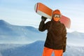 Snowboarder snowboard portrait mountain top orange