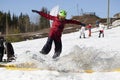 Snowboarder on a snowboard.Snowboarding down the mountain with overcoming