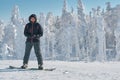 Snowboarder staing on a background of white snowy forest Royalty Free Stock Photo