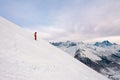 Snowboarder is standing on the snow hill