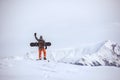 Snowboarder stands on mountain top ski tour concept