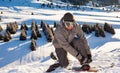 Snowboarder stands mountain top, buttoning fastening for a snowboard