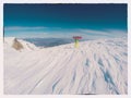 A snowboarder stands at the top of a snow-covered ski slope. Winter ski resort. . Post-processing