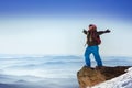 Snowboarder stands in winner pose on the top of mountain