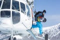 Snowboarder stepping out of helicopter Royalty Free Stock Photo