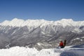 Snowboarder on the top of mountain blue sky background