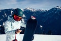 snowboarder use smatphone on winter mountain top Royalty Free Stock Photo