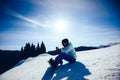 snowboarder use smatphone on winter mountain top Royalty Free Stock Photo