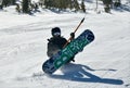 Snowboarder using t-bar ski lift to get on the top of Breckenridge Ski Resort