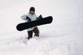 Snowboarder walking in deep show