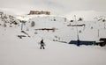 Snowboarder walking with a snowboard in the winter ski resort. Royalty Free Stock Photo