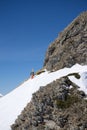 Snowboarder walking uphill for freeride