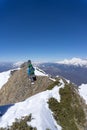 Snowboarder walking uphill for freeride