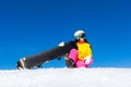 Snowboarder woman sitting on snow mountain slope Royalty Free Stock Photo