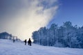 Snowboarders climbing