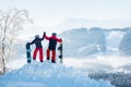 Snowboarders couple standing on top of the mountain Royalty Free Stock Photo