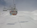 Snowboarders in lift in Dolomites