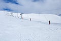 Snowboarders rising the mountain in russian polar ski resort