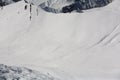 Snowboarders and skiers downhill on off piste slope. Top view. Caucasus Mountains, Georgia, ski resort Gudauri