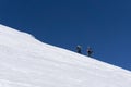 Snowboarders walking uphill for freeride