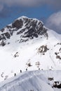 Snowboarders walking uphill for freeride