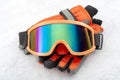 Snowboarding and skiing protective gear and winter extreme sports concept with ski goggles and cold weather gloves on