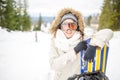 Snowboarding.Young beautiful woman with ski mask holding her snowboard at ski slope Young woman in ski resort Royalty Free Stock Photo