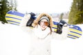 Snowboarding.Young beautiful woman with ski mask holding her snowboard at ski slope Young woman in ski resort Royalty Free Stock Photo