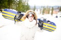 Snowboarding.Young beautiful woman with ski mask holding her snowboard at ski slope Young woman in ski resort Royalty Free Stock Photo