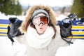 Snowboarding.Young beautiful woman with ski mask holding her snowboard at ski slope Young woman in ski resort Royalty Free Stock Photo