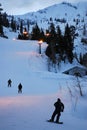 Snowboards take in the last run of the night