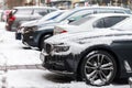 Snowbound cars parked at the roadside