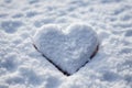 Snowbound emotion Hand shapes a heart in newly fallen snow