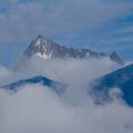 snowbound mountain ridge in dense mist