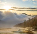 mountain valley in dense clouds at the sunset