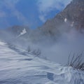 snowbound mountain valley in dense mist