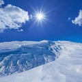 snowbound mountain valley at sunny day