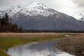 Snowcapped mountain and deep creek near Chinitna Bay Alaska USA Royalty Free Stock Photo