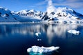 Snowcapped mountains in beautiful landscape, reflecting in blue water, ice flows, Lemaire Channel near Paradise Bay, Antarctica Royalty Free Stock Photo