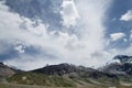 Snowcapped mountains under deep blue sky and beautiful clouds