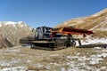 Snowcat on mountain slope. Ski resort Dombai, Karachay-Cherkessia, Russia. November 24, 2016