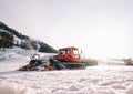 Snowcat - Red caterpillar vehicle for maintenance of mountain ski slopes skiing winter resort Rosa Khutor. Royalty Free Stock Photo