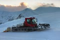 Snowcat rides to work in the evening Royalty Free Stock Photo