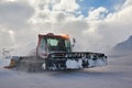 Snowcat rides to work in the evening Royalty Free Stock Photo